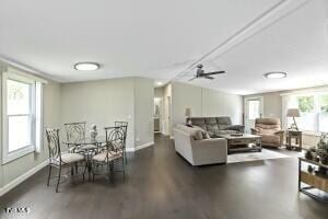 living room featuring a ceiling fan and baseboards