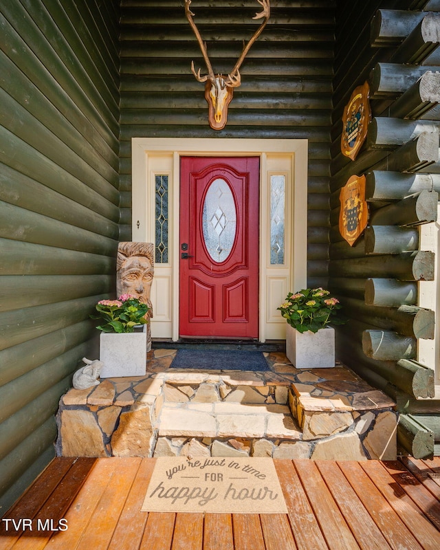view of exterior entry with log exterior