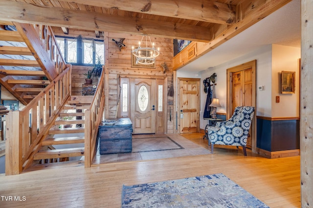 foyer entrance featuring wood ceiling, stairway, beamed ceiling, and wood-type flooring
