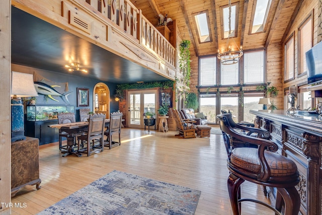 living room featuring high vaulted ceiling, wooden ceiling, and hardwood / wood-style flooring