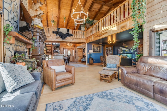 living area featuring high vaulted ceiling, beamed ceiling, a notable chandelier, wood finished floors, and wooden ceiling