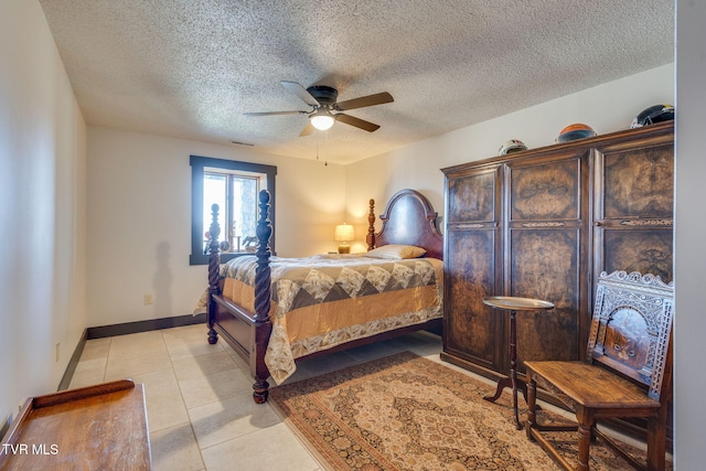 bedroom featuring a textured ceiling, visible vents, baseboards, ceiling fan, and light tile patterned floors