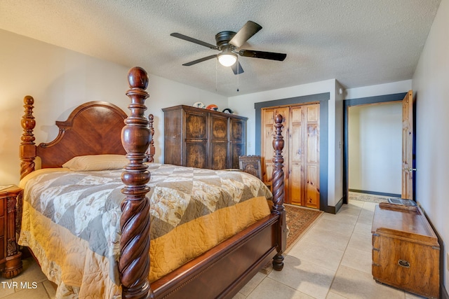 bedroom with light tile patterned flooring, a ceiling fan, and a textured ceiling
