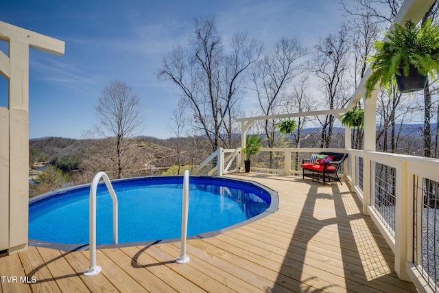 outdoor pool featuring a wooden deck