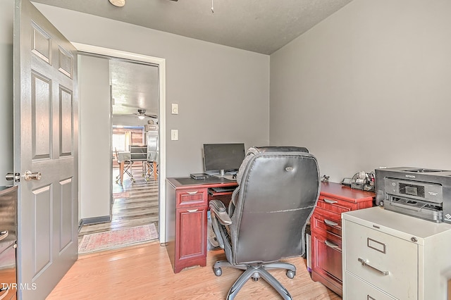 home office with ceiling fan and light wood-type flooring
