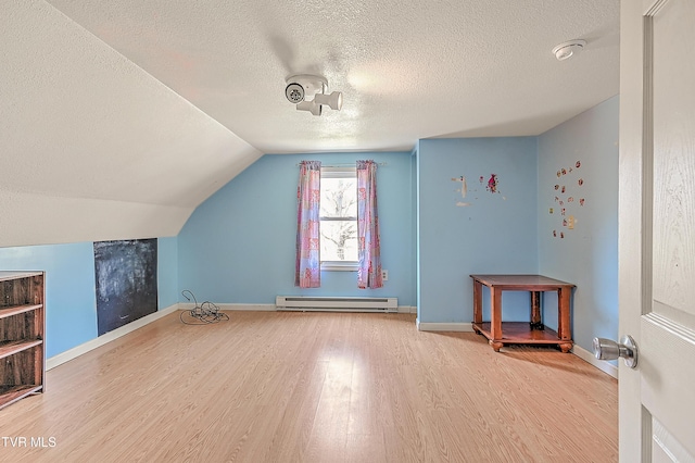 bonus room with a baseboard radiator, baseboards, lofted ceiling, and wood finished floors