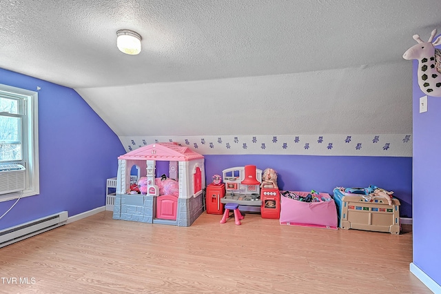 playroom with a baseboard radiator, baseboards, vaulted ceiling, and wood finished floors