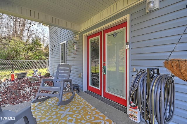 view of exterior entry featuring fence