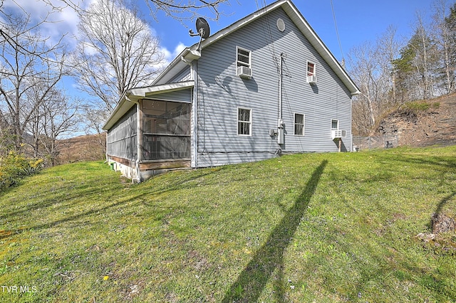 back of house with a lawn, a sunroom, and cooling unit