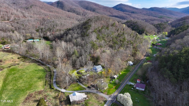 aerial view with a wooded view and a mountain view