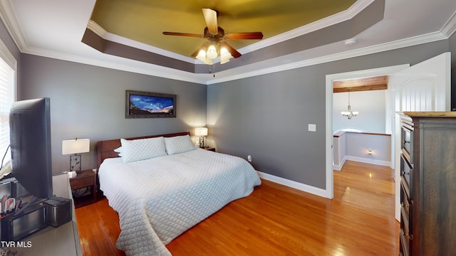 93 Bridgewater Ct Unit 93, Johnson City, TN 37615 - bedroom with baseboards, ceiling fan, crown molding, a tray ceiling, and wood finished floors