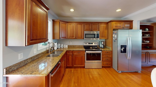 93 Bridgewater Ct Unit 93, Johnson City, TN 37615 - kitchen with a sink, brown cabinetry, appliances with stainless steel finishes, and light stone counters