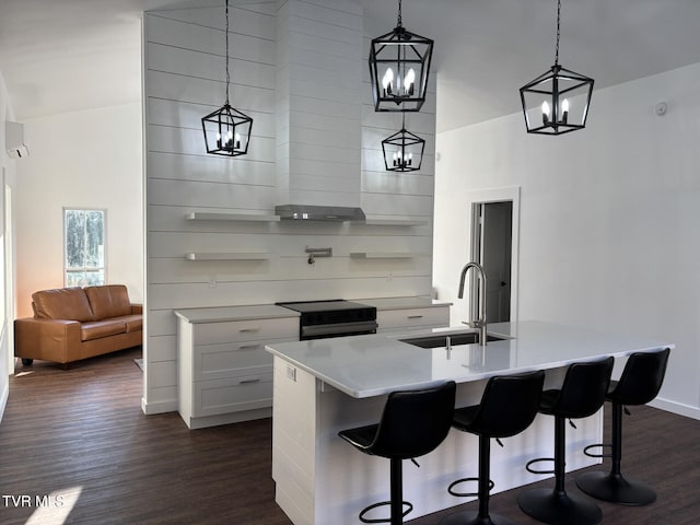 kitchen featuring light countertops, an inviting chandelier, a sink, dark wood-style floors, and black range with electric cooktop