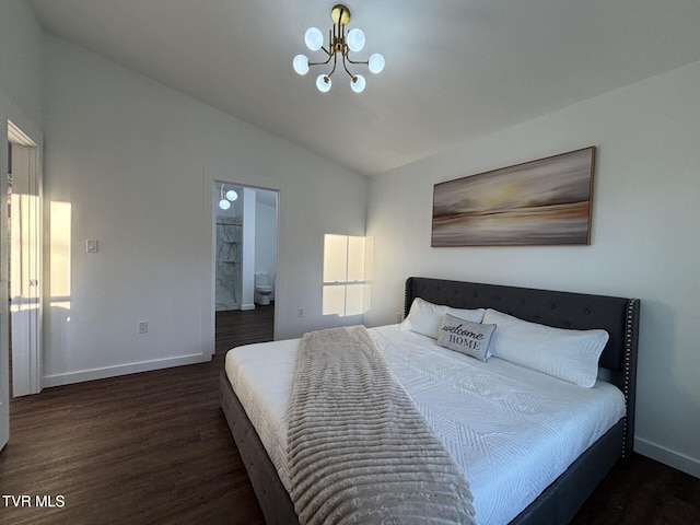 bedroom featuring baseboards, wood finished floors, ensuite bath, vaulted ceiling, and a notable chandelier