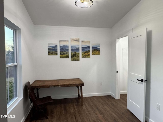 living area with baseboards and dark wood-style flooring