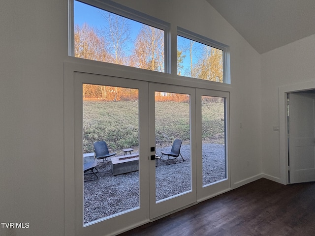 entryway with dark wood-type flooring, high vaulted ceiling, baseboards, and french doors