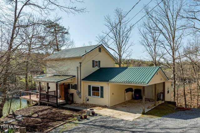 403 Deerlick Rd, Piney Flats, TN 37686 - view of front of property with driveway, a standing seam roof, an attached carport, a wooden deck, and metal roof