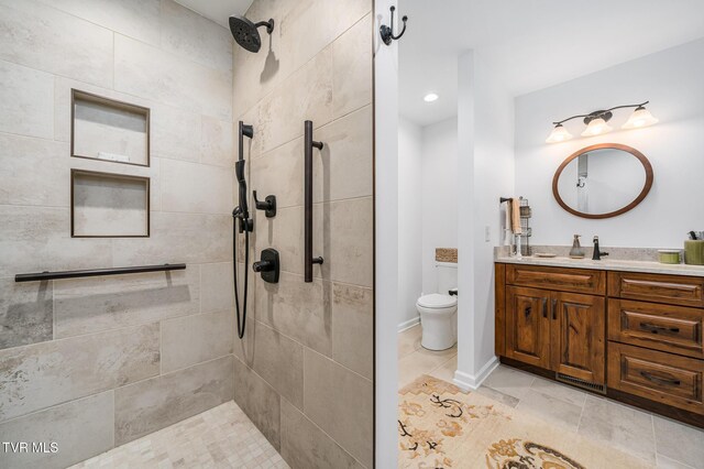 403 Deerlick Rd, Piney Flats, TN 37686 - bathroom featuring toilet, vanity, tile patterned floors, and tiled shower