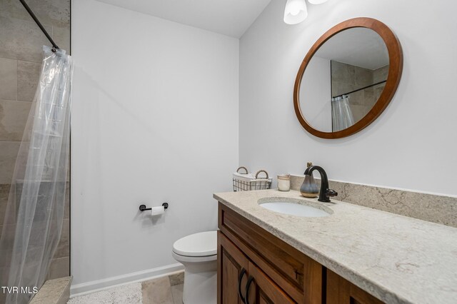 403 Deerlick Rd, Piney Flats, TN 37686 - full bathroom featuring toilet, vanity, baseboards, and a tile shower