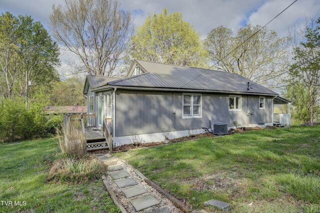 5744 Orebank Rd, Kingsport, TN 37664 - back of property with central AC unit, a deck, metal roof, and a lawn