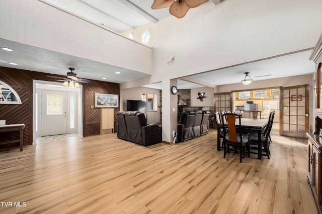 166 Lonesome Dove Ln, Elizabethton, TN 37643 - dining space featuring wooden walls, ceiling fan, light wood-type flooring, and plenty of natural light