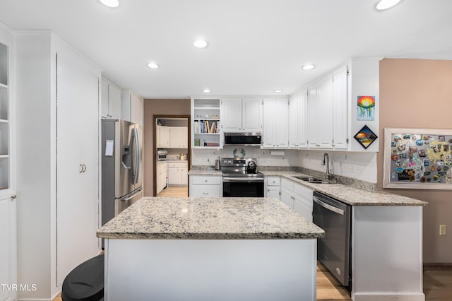 166 Lonesome Dove Ln, Elizabethton, TN 37643 - kitchen featuring open shelves, white cabinets, light stone countertops, appliances with stainless steel finishes, and a sink