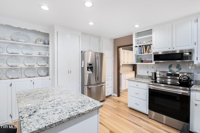 166 Lonesome Dove Ln, Elizabethton, TN 37643 - kitchen with open shelves, white cabinets, appliances with stainless steel finishes, and light wood finished floors