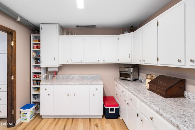 166 Lonesome Dove Ln, Elizabethton, TN 37643 - interior space featuring white cabinets, light wood finished floors, light countertops, and visible vents