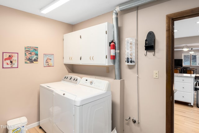 166 Lonesome Dove Ln, Elizabethton, TN 37643 - laundry area with cabinet space, baseboards, light wood finished floors, and washer and dryer