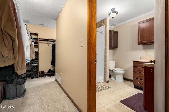 166 Lonesome Dove Ln, Elizabethton, TN 37643 - bathroom featuring a textured ceiling, tile patterned flooring, toilet, walk in shower, and baseboards