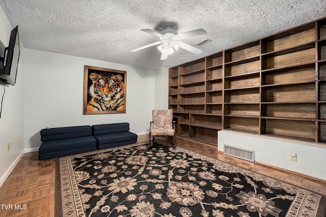 166 Lonesome Dove Ln, Elizabethton, TN 37643 - living area with a textured ceiling, ceiling fan, baseboards, and visible vents