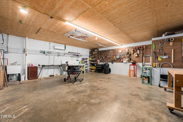 166 Lonesome Dove Ln, Elizabethton, TN 37643 - garage featuring a wall mounted AC, a sink, and a workshop area