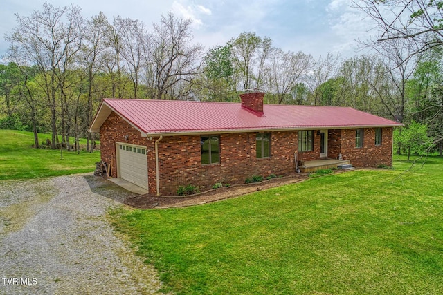 ranch-style home with a front yard, driveway, a chimney, and brick siding