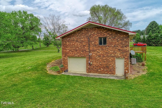 view of home's exterior featuring a yard, brick siding, central air condition unit, driveway, and an attached garage