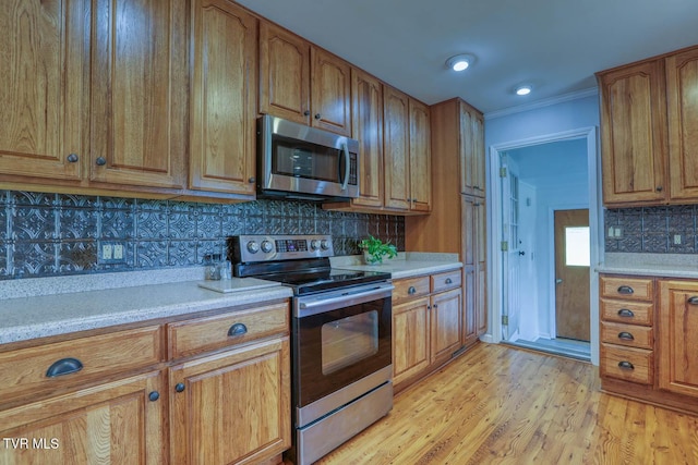 kitchen featuring backsplash, stainless steel appliances, and light countertops