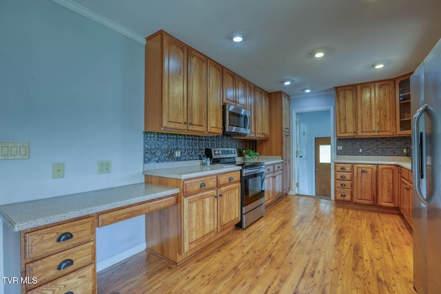 kitchen featuring brown cabinetry, stainless steel appliances, and light wood-style flooring