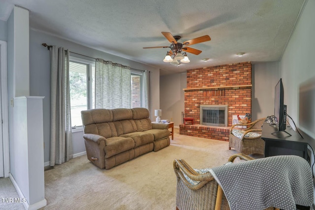 carpeted living room featuring a brick fireplace, a textured ceiling, ceiling fan, and baseboards