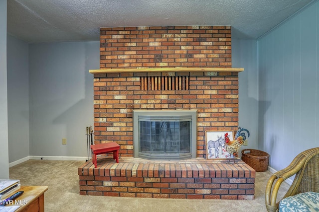 carpeted living room with a textured ceiling, baseboards, and a fireplace