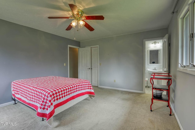 bedroom with baseboards, a ceiling fan, connected bathroom, and carpet flooring