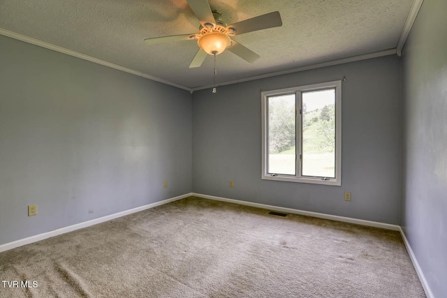 carpeted spare room featuring ceiling fan, baseboards, visible vents, a textured ceiling, and crown molding