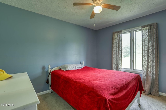 bedroom featuring carpet, baseboards, a ceiling fan, and a textured ceiling