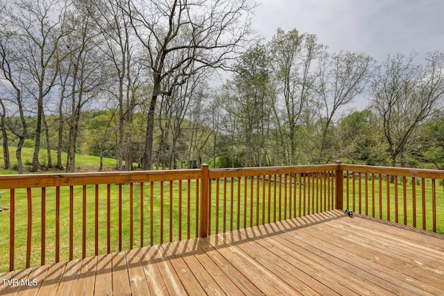 wooden deck featuring a yard