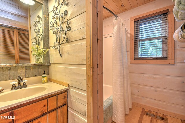 521 Baywood Dr, Piney Flats, TN 37686 - bathroom featuring vanity, a shower with curtain, wooden walls, and wood finished floors