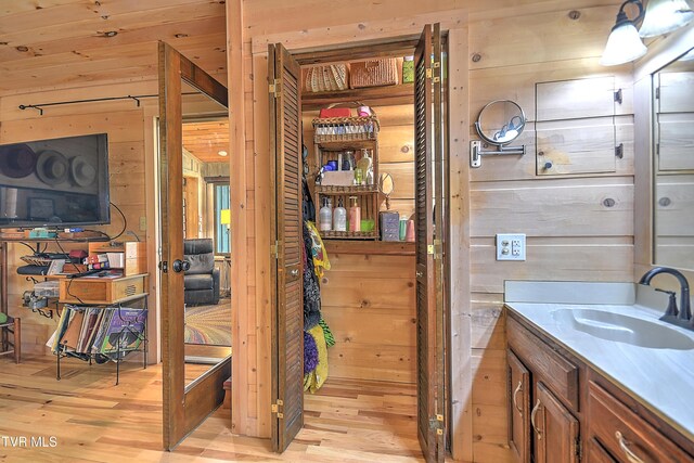 521 Baywood Dr, Piney Flats, TN 37686 - bathroom featuring wood walls, wood finished floors, and vanity