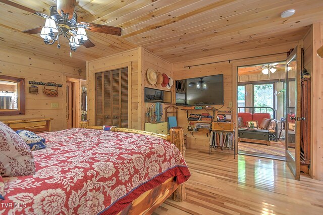 521 Baywood Dr, Piney Flats, TN 37686 - bedroom featuring wood walls, wood finished floors, wooden ceiling, and access to outside