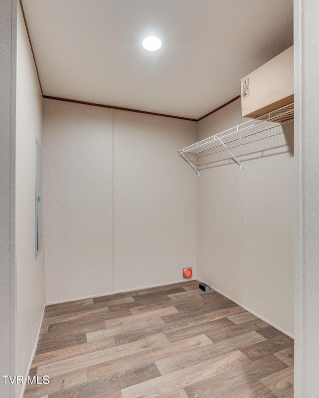 washroom featuring wood finished floors and ornamental molding