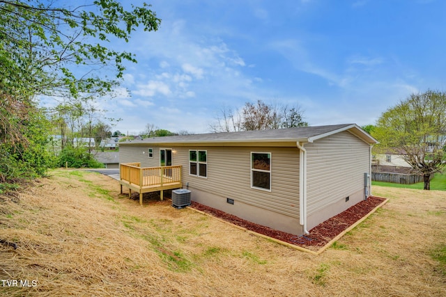 back of house featuring a yard, a deck, crawl space, and cooling unit