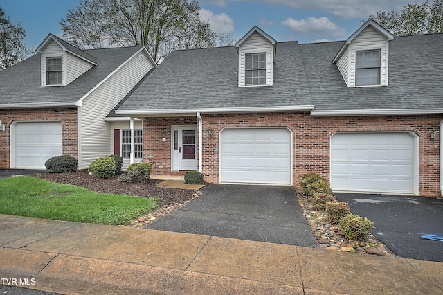 cape cod home with brick siding, aphalt driveway, and roof with shingles