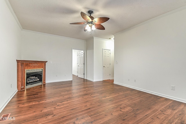unfurnished living room featuring a fireplace, dark wood-type flooring, crown molding, and ceiling fan