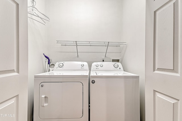 laundry room with separate washer and dryer and laundry area